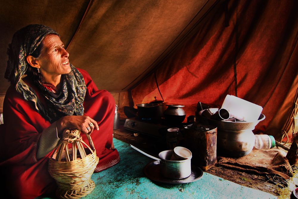 A Kashmiri lady in her makeshift tent next to the stream A Kashmiri lady in her makeshift tent next to the stream